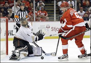 Red Wings players celebrate Henrik Zetterberg's goal in overtime to send the series back to Anaheim for a decisive Game 7.