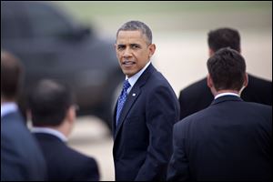 President Barack Obama turns around and pauses before entering his car at Austin Bergstrom International Airport.
