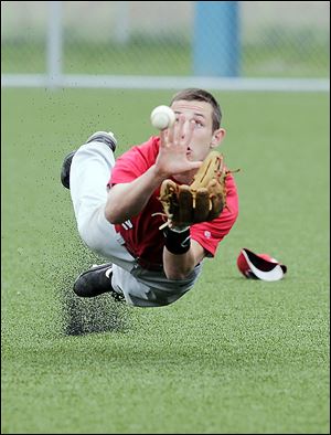 Central Catholic outfielder Colin Kaucher dives for a sinking liner.