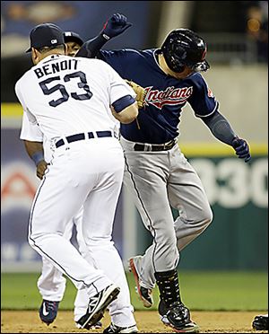 The Tigers’ Joaquin Benoit (53) tags out the Indians' Asdrubal Cabrera at first base on Friday.