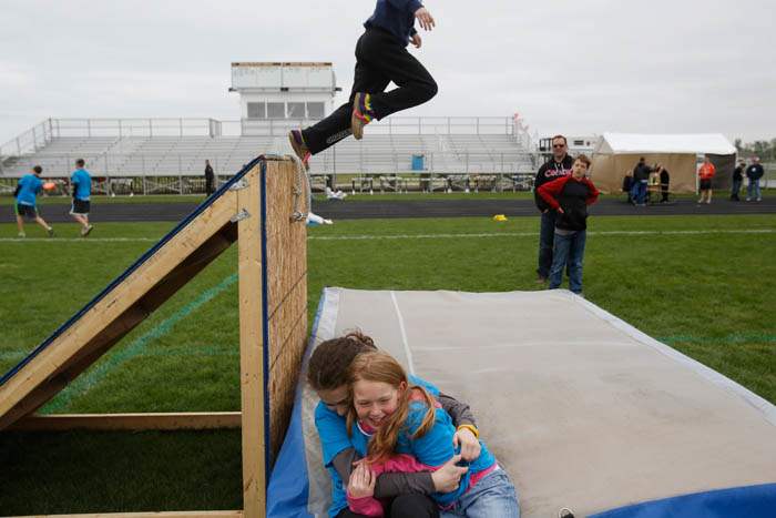 As-another-child-jumps-from-the-top-of-the-obstacle-course-Mikayla-Simpson-14-left-hugs-Caris-Welsh-9-right