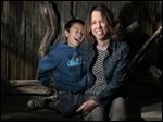  Tara Sievers and her son, Bodhi, 7, pose for portrait at their Belmont Shores home. The City of Long Beach is cutting hours for some part-timers to avoid benefit costs under the federal healthcare law. Longtime parks employee Sievers is affected by this and has complained to city officials about them hurting workers and dodging the new law.