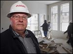  Richard Vap, owner of South Valley Drywall, poses for a photo at a home construction site with one of his crews working in the background in Lakewood, Colo.