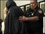  Michael A. Fay, 17, is escorted into the Putnam Municipal Court courtroom by Putnam County Sheriff Michael C. Chandler for charges of grand theft auto.