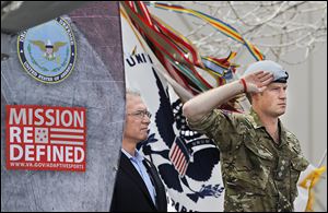 Britain’s Prince Harry salutes during the opening ceremony for the Warrior Games at the U.S. Olympic Training Center in Colorado Springs. At left is Robin Lineberger, CEO of Deloitte, a sponsor of the games.