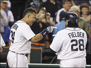 The Tigers' Miguel Cabrera, left, points to teammate Prince Fielder during a recent game. Both sluggers are on pace to rack up more than 160 RBIs each, which has not been accomplished since 1999.