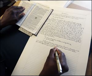 Phillip Patterson transcribes the King James Bible at this home on April 30 in Philmont, N.Y. Four years after starting with Genesis, Patterson, finished up the final lines of the Book of Revelation during a ceremony today at his church, St. Peter's Presbyterian in Spencertown, N.Y.