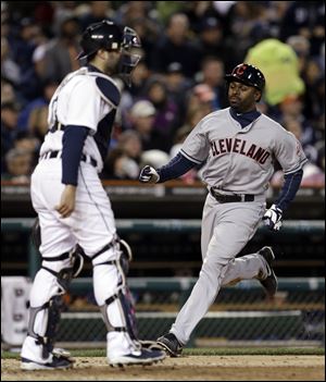 Cleveland Indians' Michael Bourn, right, scores past Detroit Tigers catcher Alex Avila on an Asdrubal Cabrera single in the sixth inning tonight in Detroit.
