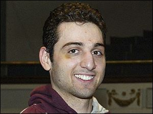 In this file photo, Tamerlan Tsarnaev smiles after accepting the trophy for winning the 2010 New England Golden Gloves Championship in Lowell, Mass. 