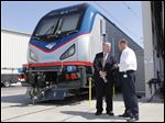 Joseph Boardman, Amtrak President and CEO, left, talks with Michael Cahill, president of Siemens Rail Systems, next to one of the new Amtrak Cities Sprinter Locomotive that was built by Siemens in Sacramento, Calif.  The new electric locomotive will run on the Northeast intercity rail lines and  replace Amtrak locomotives that have been in service for 20 to 30 years.