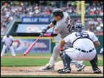  Cleveland's Jason Kipnis smacks a two-run double off Tigers starting pitcher Rick Porcello during the third inning. The double tied the game, but the Indians were later forced to rally in the ninth.