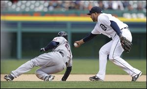 Cleveland Indians' Michael Bourn is tagged out by Detroit Tigers shortstop Jhonny Peralta on a rundown during the 10th inning of a baseball game in Detroit.