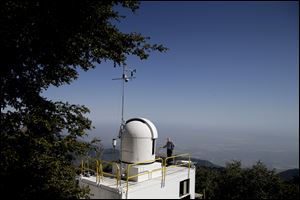 Senior research scientist Stanley Sander stands on the rooftop of the California Laboratory for Atmospheric. Remote Sensing (CLARS) facility at Mount Wilson, Calif. A mile above this city, sensors gaze down on the basin from atop Mount Wilson the way a satellite fixates on Earth, collecting pieces of information about Los Angeles' carbon footprint.