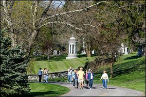 Locals enjoy beautiful weather as well as get in shape while learning history during a weekly walking program at  historic Woodlawn Cemetery and Arboretum on West Central Avenue in West Toledo.