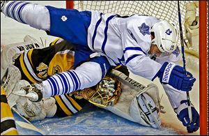Toronto's Joffrey Lupul bends Boston Bruins goalie Tuukka Rask's head to his leg as he crashes into him in the second period.