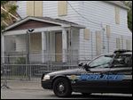  A Cleveland police patrol car sits in front of the boarded up home of Ariel Castro in Cleveland today.