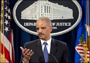 Attorney General Eric Holder is questioned during a news conference today.