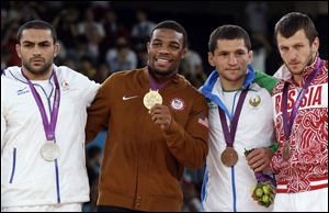 From left: Silver medalist Sadegh Saeed Goudarzi, from Iran; gold medalist Jordan Ernest Burroughs, from the United States; bronze medalist Soslan Tigiev, from Uzbekistan; and bronze medalist Denis Tsargush, from Russia, participate in the medals ceremony for men's 74-kg freestyle wrestling competition at the 2012 Summer Olympics, in London, last August.