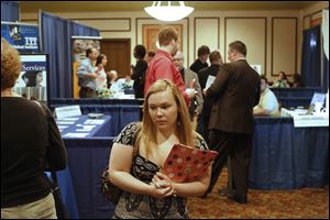 Lindsay Fuerst of Liberty Center, Ohio, makes her way from booth to booth during  the 2013 Career Expo at the Holiday Inn French Quarter in Perrysburg. Organizers say between 300 and 500 potential employees turned out Tuesday to meet representatives from 47 companies. 