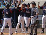  Mud Hens second baseman Brandon Douglas  is congratulated by teammates after hitting a three-run homer in second inning.