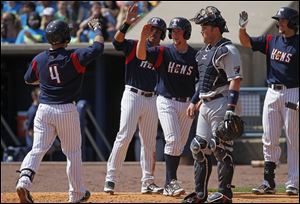 Mud Hens second baseman Brandon Douglas  is congratulated by teammates after hitting a three-run homer in second inning.
