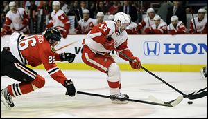 Detroit's Pavel Datsyuk controls the puck past Chicago's Michal Handzus Wednesday night in the Western Conference semifinals.