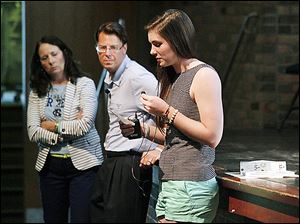 Cousin Katie McKernen, right, reads the pledge that Brian and Cindy Hoeflinger, left, wrote in repsonse to their son's death in a drunk-driving accident in February.