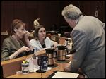  Denise Fox of Aurora House, left, and Renee Palacios of Family House speak with Toledo City Council member George Sarantou at Thursday’s meeting on funding.