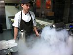  Sous Chef James Combs. Liquid nitrogen smoke overflows from the ice cream mixture. 