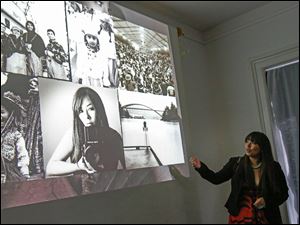 Matika Wilbur, right, speaks to a packed room about her experiences photographing indigenous people in America during a lecture at the River House Arts Gallery.