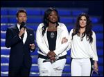  Host Ryan Seacrest, left, and finalists Candice Glover, center, and Kree Harrison speak on stage at the 'American Idol' finale Thursday night.