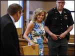  Terri Camp Kruse of Oak Harbor smiles at attorney William Hayes after being granted limited driving privileges by Judge Bruce Winters during a hearing in Ottawa County Common Pleas Court today.