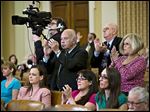  Members of the audience applaud after Rep. Mike Kelly (R., Pa.), a member of the House Ways and Means Committee, criticized ousted IRS chief Steven Miller during a hearing on IRS scrutiny of conservative groups.  