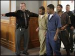  Keshawn Jennings, Antwaine Jones, and James Moore, enter Lucas County Common Pleas Court.