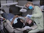  Navy veteran Terry Keller of Toledo receives dental care from Karen Knowles during the fourth annual Stars, Stripes and Smiles event at Hires Dental Care in Toledo. 