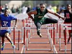  Dionte Carey of Start defeats DeMarkus Darrington of Woodward in the City League track meet on Friday night. Carey’s big night led the Spartans to the team title.