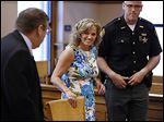  Terri Camp Kruse leaves Ottawa County Common Pleas Court on Friday with her attorney, William Hayes, left, after being granted limited driving privileges by Judge Bruce Winters.