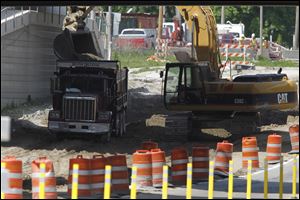 Scene of where construction crew ruptured a natural gas line, on Upton Rd. under I-475.