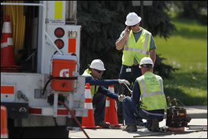 Columbia Gas crews work on fixing gas leak on Upton Rd. under I-475 in Toledo.