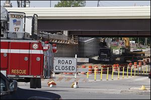 Construction crews with a bulldozer struck a 16-inch medium-pressure gas line on Upton Avenue at Central Avenue under I-475, clogging traffic for hours and forcing the evacuation of five homes.