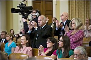 Members of the audience applaud after Rep. Mike Kelly (R., Pa.), a member of the House Ways and Means Committee, criticized ousted IRS chief Steven Miller during a hearing on IRS scrutiny of conservative groups.  