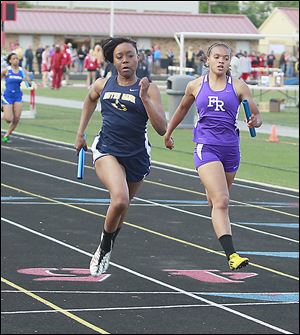 Notre Dame's Chantalia Young defeats Fremont Ross' Ariana Spencer at the finish of the 400-meter relay. Young also won the 100 and 200.