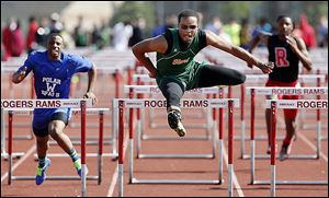 Dionte Carey of Start defeats DeMarkus Darrington of Woodward in the City League track meet on Friday night. Carey’s big night led the Spartans to the team title.