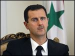  FILE - This Wednesday, Aug. 19, 2009 file photo shows Syrian President Bashar Assad, seen, during a meeting with his Iranian counterpart Mahmoud Ahmadinejad, unseen, at the presidency in Tehran, Iran. Syrian President Bashar Assad says he won't step down before elections are held in his war-ravaged country. The Syrian leader's comments, published Saturday in the Argentine newspaper Clarin, highlight the difficulties the U.S. and Russia face in getting the Assad regime and Syria's political opposition to the table at an international conference envisioned for next month. (AP Photo/Vahid Salemi, File)