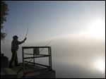  Terry Van Bibber, Toledo, casts his line out into the Maumee River as fog envelops the area.