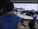  South Koreans watch TV news showing a footage of North Korean missiles on a military parade, at a Seoul Train Station in Seoul, South Korea