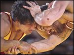  Freestyle wrestlers Mehdi Taghavi Kermani, left, from Iran, and Kellen Russell from Ann Harbor, Mich., compete at an international wrestling exhibition at Grand Central Terminal on Wednesday, May 15, 2013, in New York. Kermani won the bout. The event dubbed 