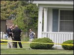  State and local authorities investigate a fatal shooting and home invasion on South River Road in Waterville Township.