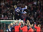  Paris Saint Germain's midfielder David Beckham is thrown in the air by his teammate at the end of their French League One soccer match against Brest, today at the Parc des Princes stadium, in Paris.