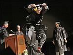  Zander Epps of San Diego jumps as he crosses the stage to receive his bachelor’s degree in interdisciplinary studies during Lourdes University’s commencement ceremony.